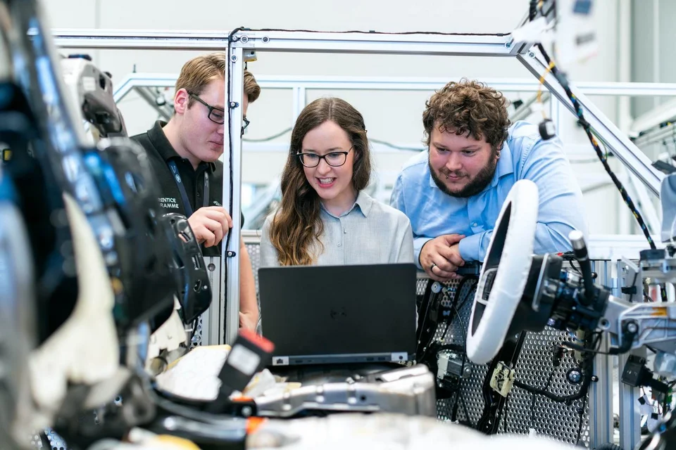 Studierende arbeiten gemeinsam an einer technischen Konstruktion.
